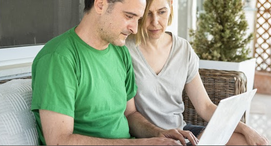 Man and woman looking at a laptop