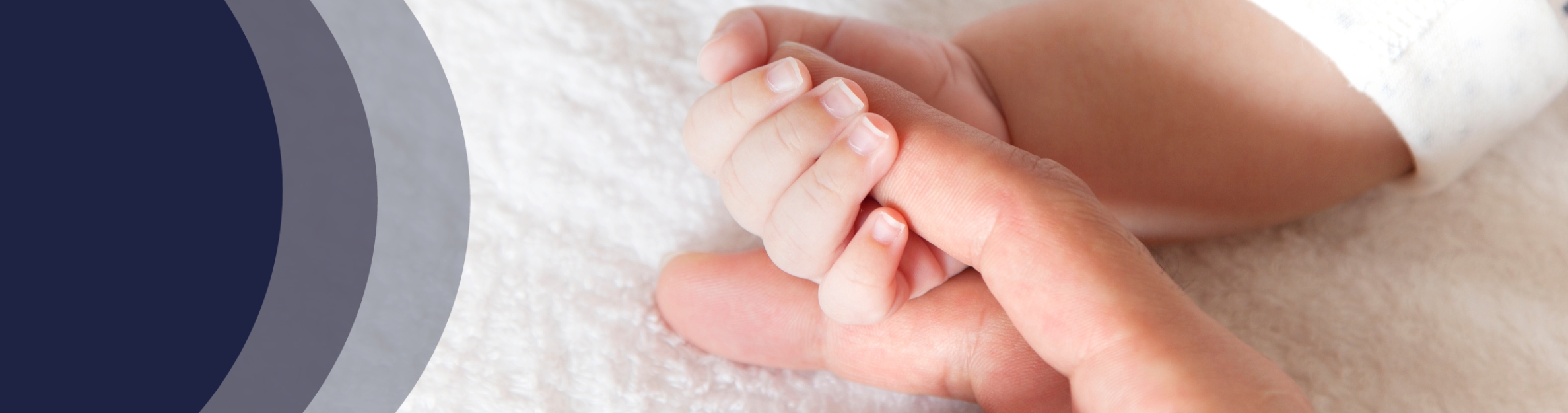 a baby's hand holding an adult finger