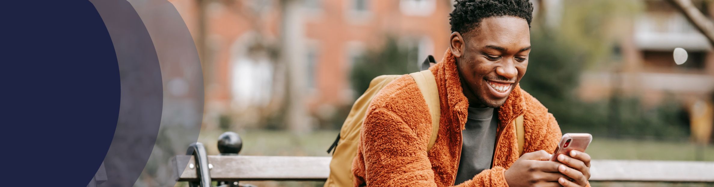 African American man smiling at cell phone