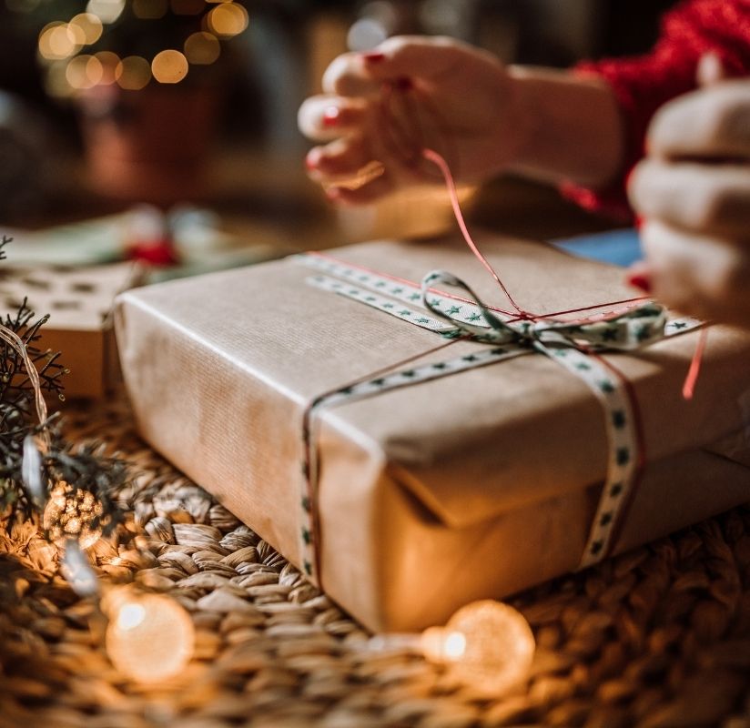 hands wrapping a Christmas present