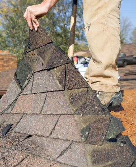 pulling shingles from a roof