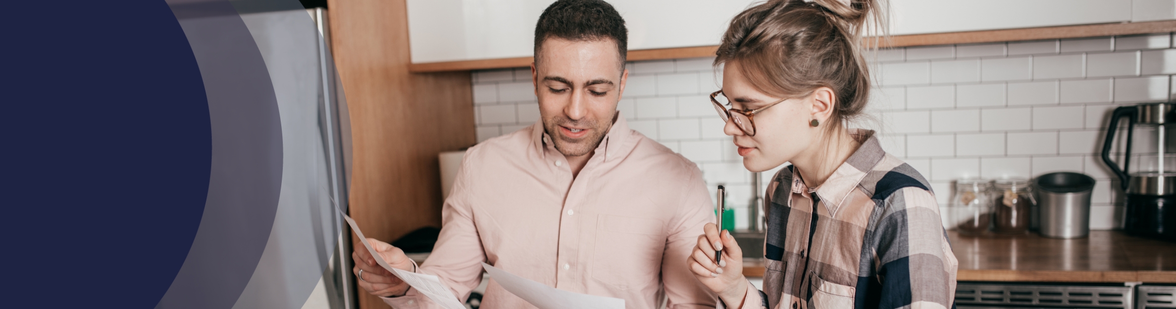 Couple looking at papers in the kitchen