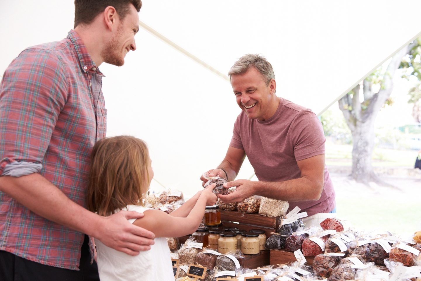 Father & daughter buying at farmers market