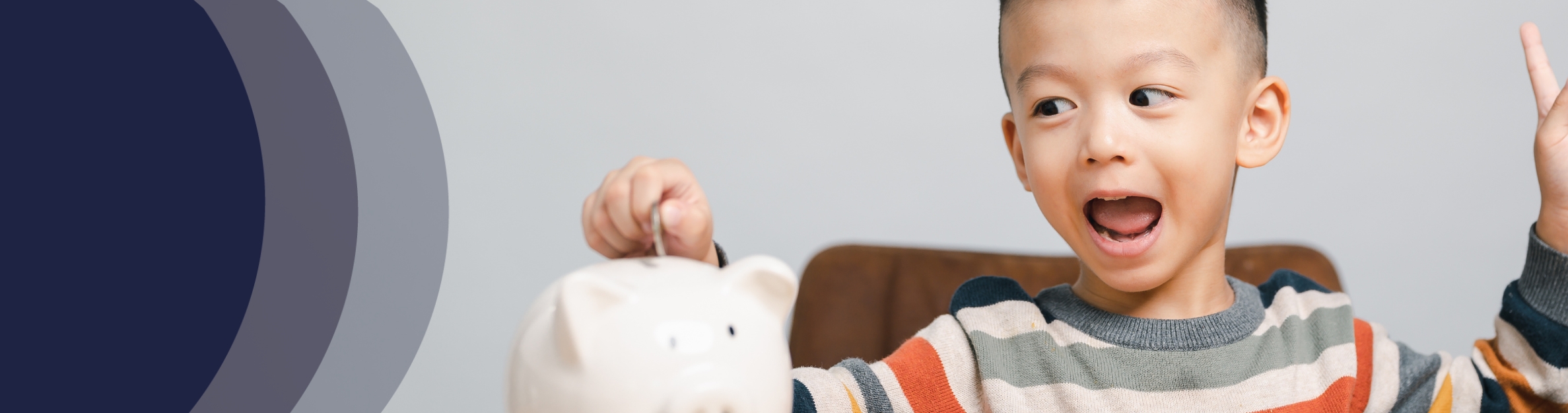 excited boy with piggy bank