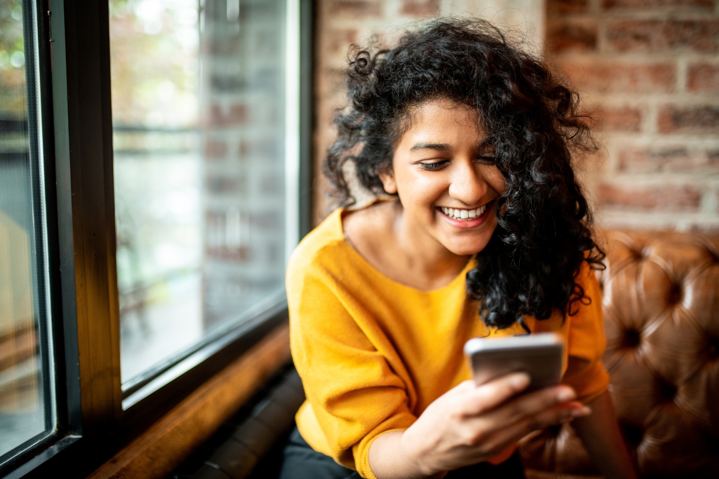 woman smiling at cell phone