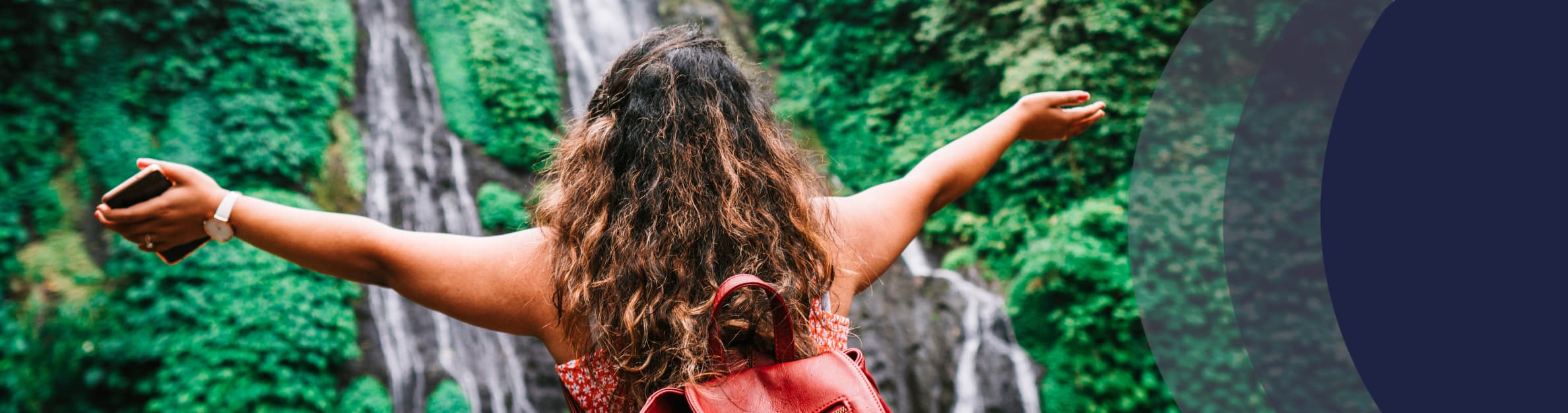 woman standing in front of a waterfall