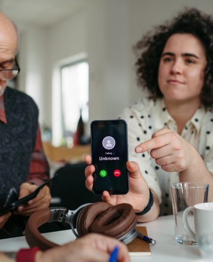 woman holding a phone with an unknown number
