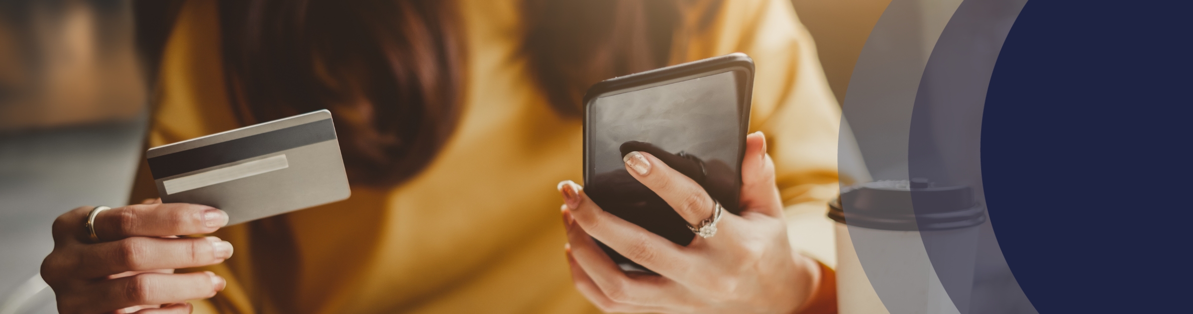 hand holding a cell phone and a credit card