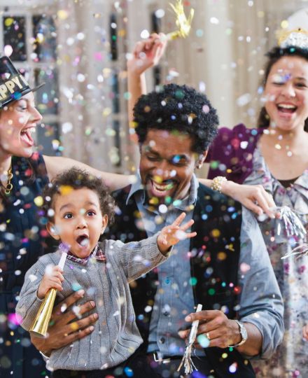 family throwing confetti for the new year