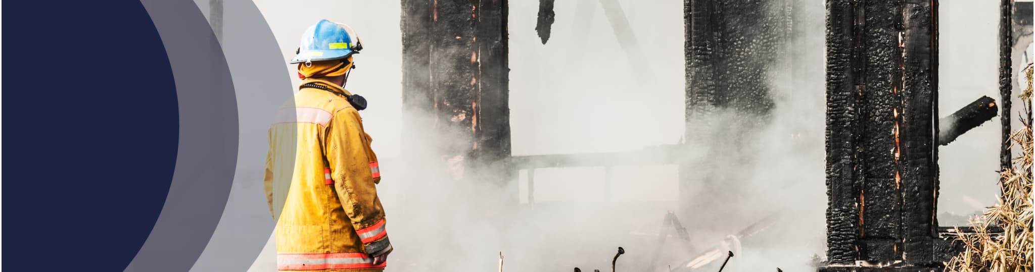 firefighter surveys the smoldering remains of a business