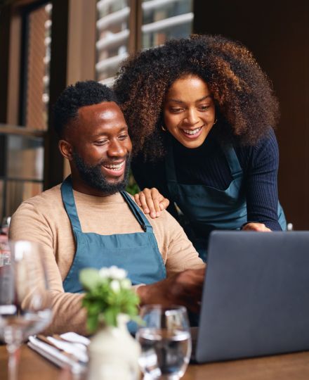 black business owners reviewing business insurance at computer