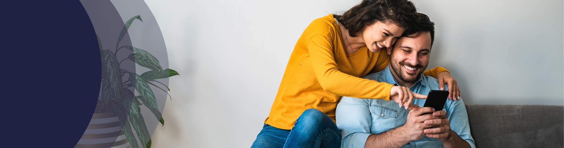 smiling couple looking at cell phone