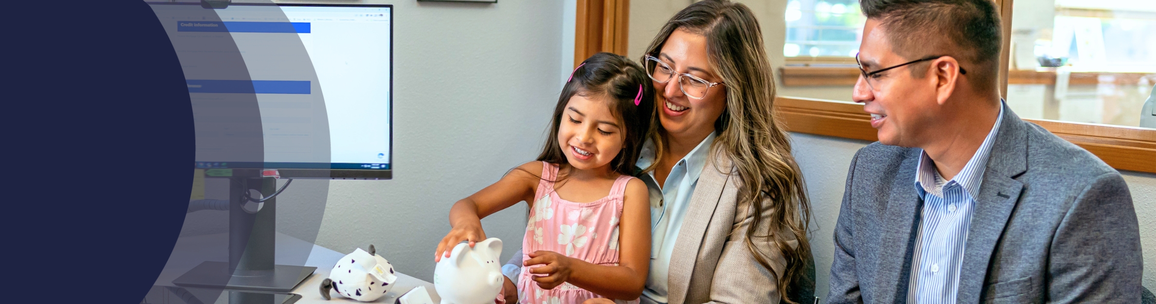 family sitting in bank office with piggy bank