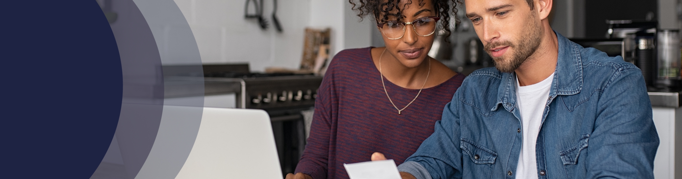 couple looking at a bill by laptop